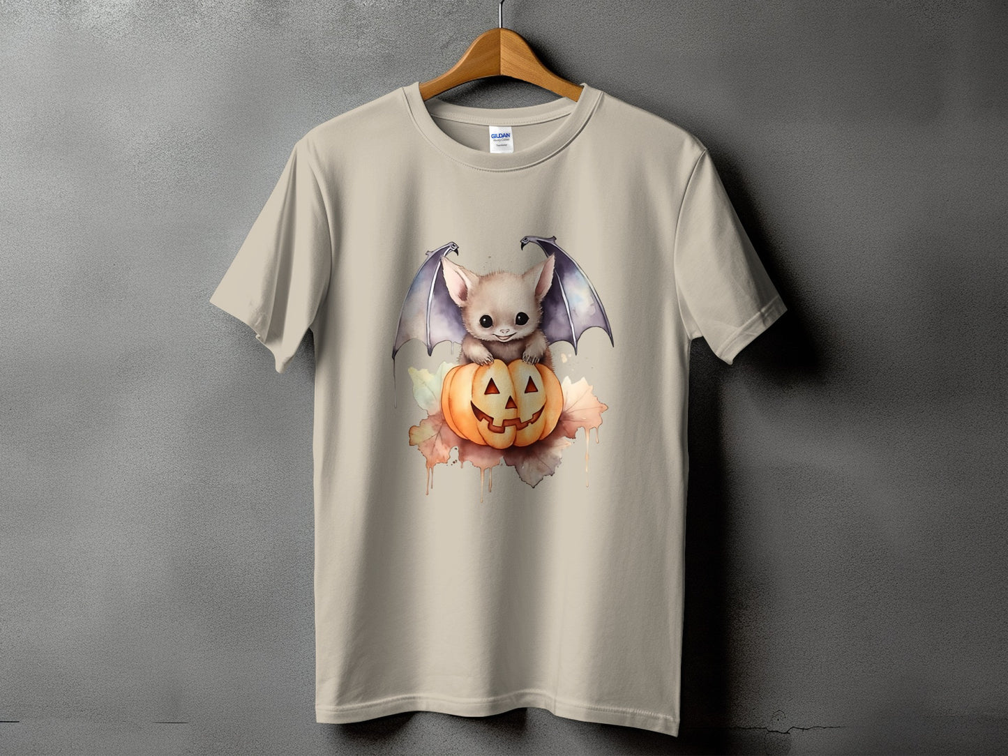 Cream t-shirt with watercolor art of a bat on a Halloween pumpkin.