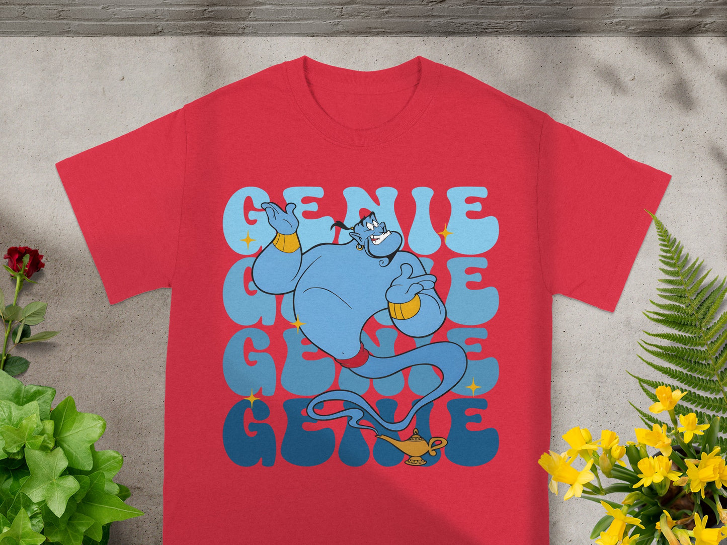 Red t-shirt with blue genie and yellow lamp graphic, text "GENIE".