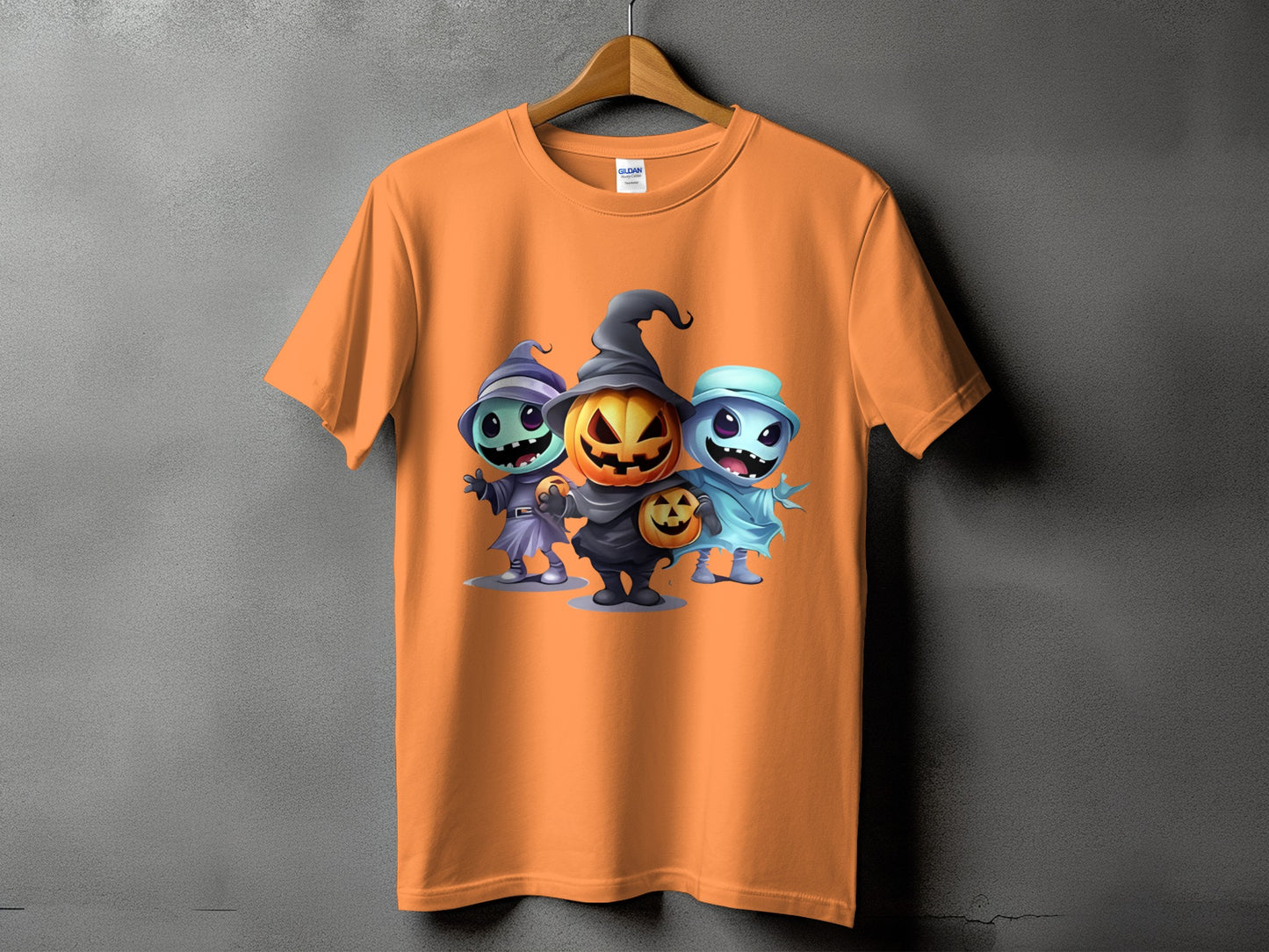 Orange t-shirt with Halloween characters: pumpkin, witch, and ghost.