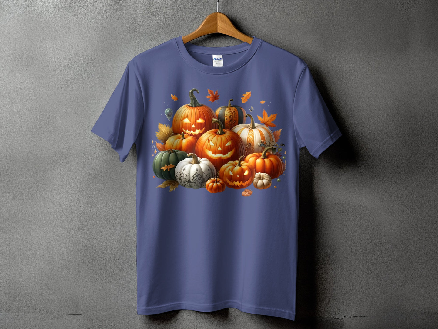 T-shirt with a pile of carved and decorative pumpkins and autumn leaves.