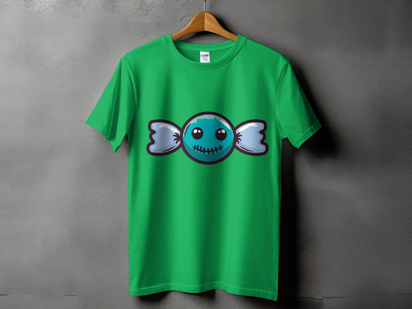 Green t-shirt with a cartoon candy graphic featuring a friendly, stitched-mouth monster face.