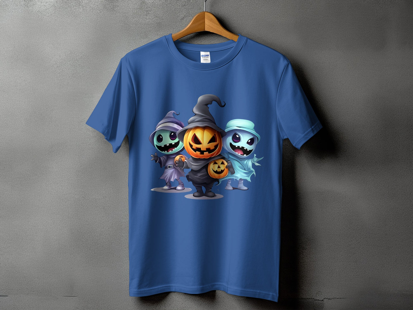 Blue t-shirt with cartoon Halloween characters: witch, pumpkin, and ghost.