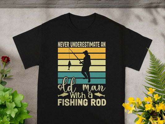 Black t-shirt with "Never underestimate an old man with a fishing rod" text.