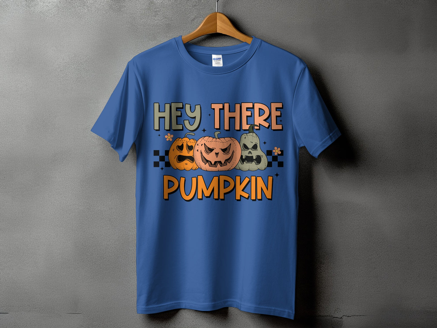Blue t-shirt with Halloween graphic text "HEY THERE PUMPKIN" and three pumpkins.