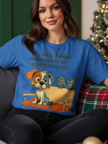 Blue t-shirt with cartoon dog and birds and text "Oh, sorry. I didn't realize you're an expert in my life."