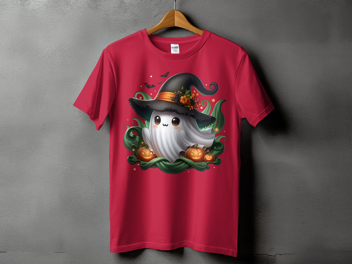 Red t-shirt with a cartoon ghost wearing a witch hat, surrounded by pumpkins and bats.