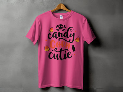 Pink t-shirt with "Candy Corn Cutie" Halloween text and skull graphic.