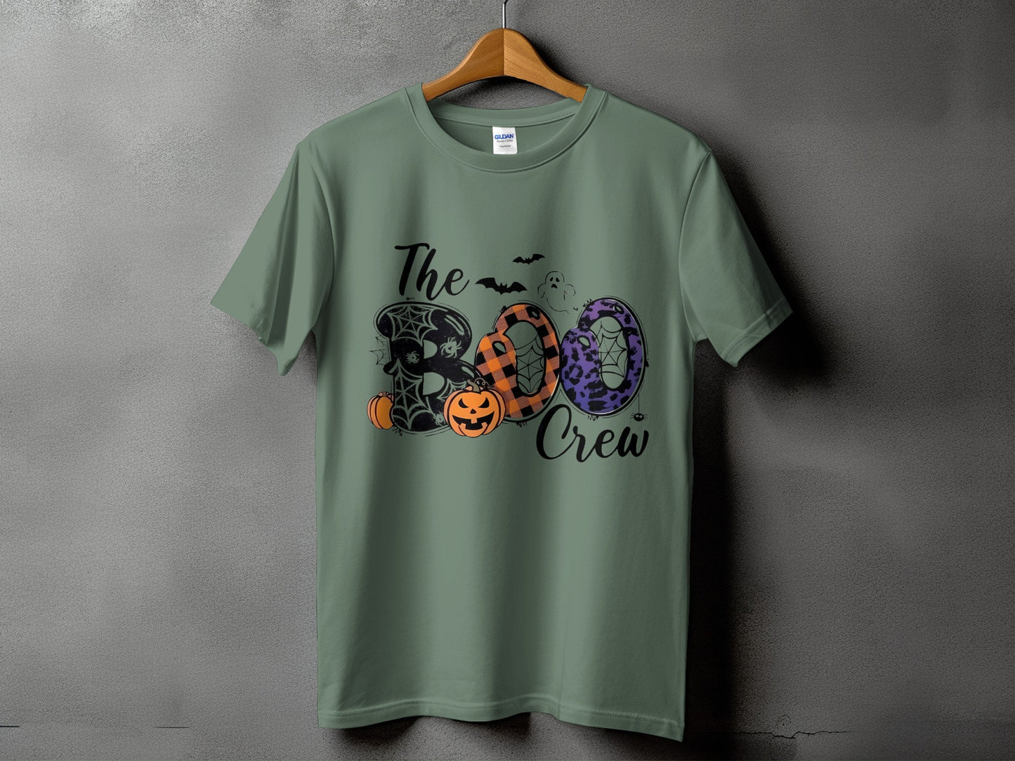 Green t-shirt with "The Boo Crew" Halloween graphic featuring pumpkins and spooky designs.
