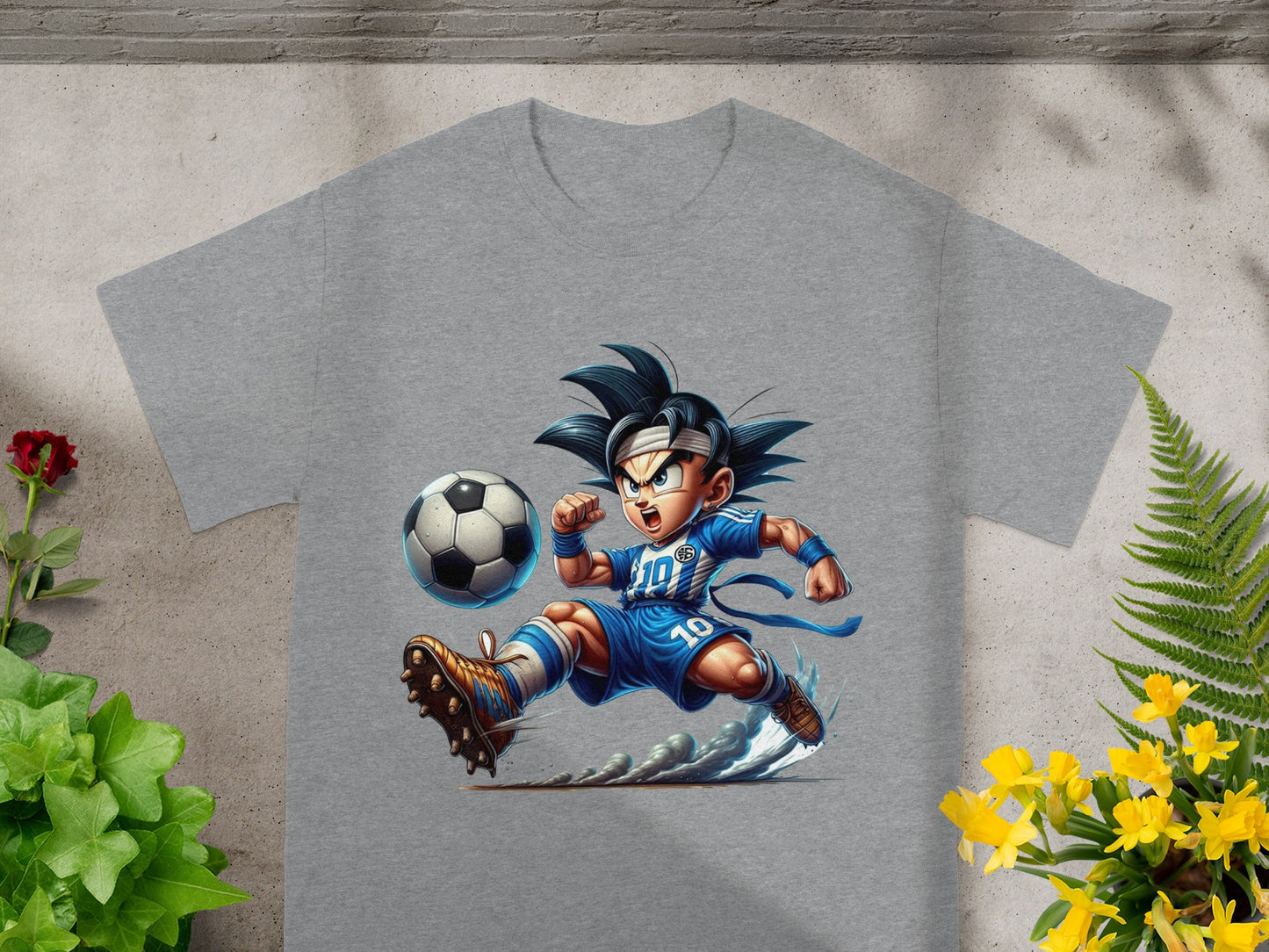 Goku in blue soccer uniform kicking a soccer ball on a grey t-shirt.