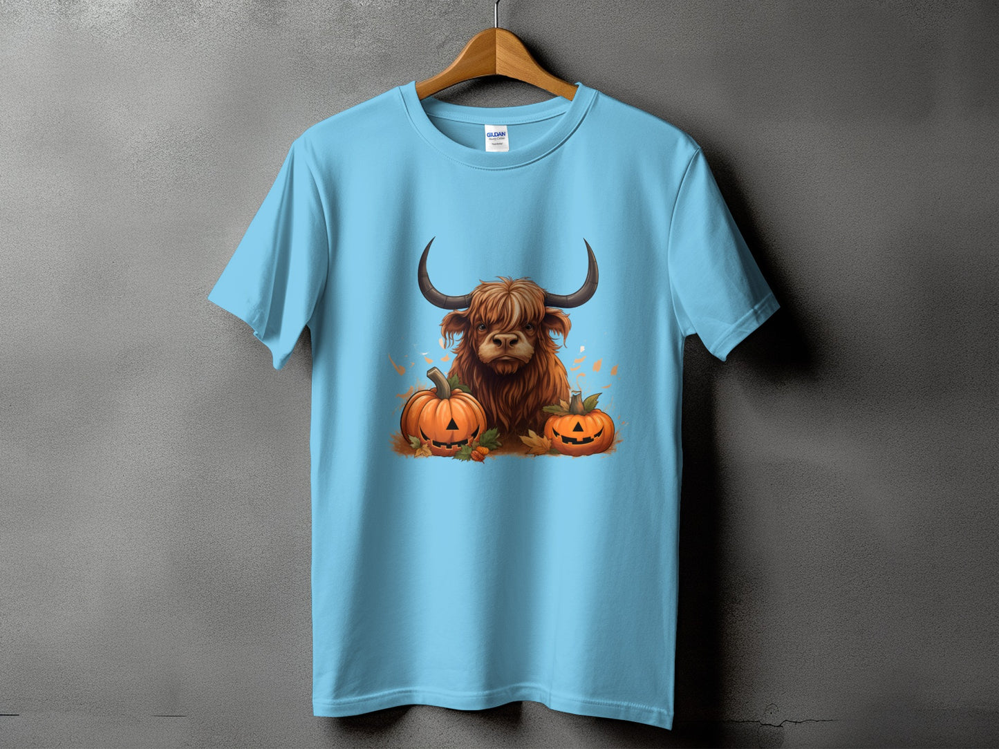 Light blue t-shirt with Highland cow and pumpkins graphic.