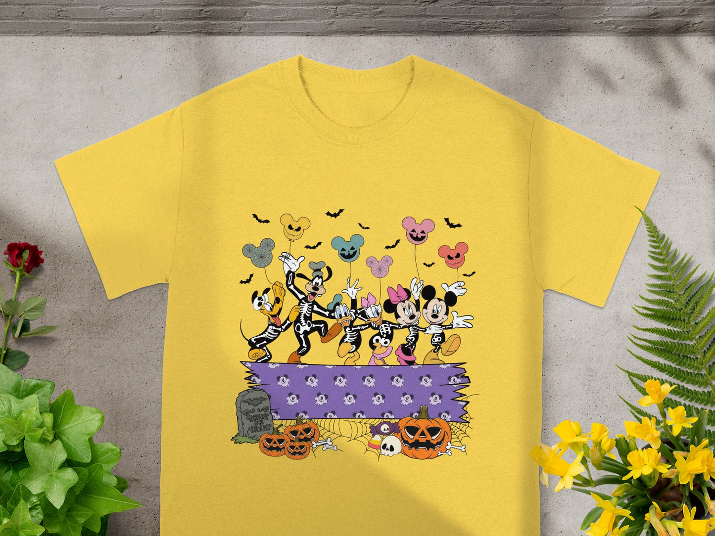 Mickey and friends in skeleton costumes with Halloween-themed balloons and decorations.