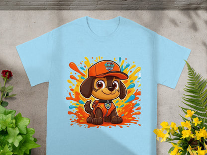Paw Patrol character Chase on a light blue t-shirt with colorful paint splatters.