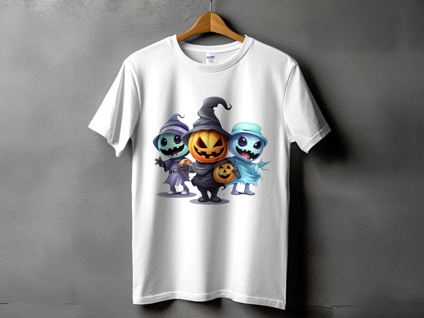 White t-shirt with cartoon Halloween characters: pumpkin, ghost, and witch.