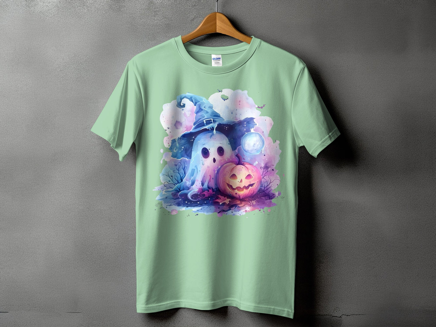 Light green t-shirt with watercolor ghost and jack-o-lantern Halloween graphic.