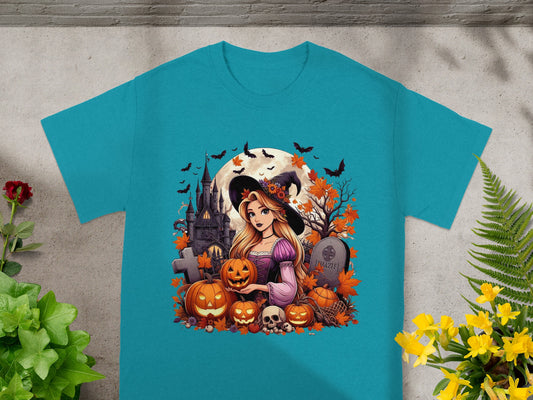 Cartoon witch with pumpkins and haunted castle Halloween graphic on a teal t-shirt.