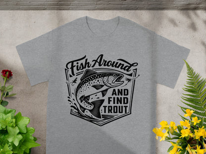Grey t-shirt with black graphic of a jumping trout and text "Fish Around And Find Trout".