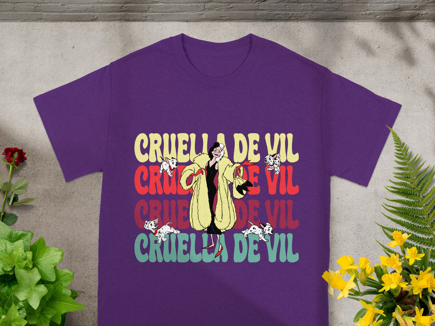 Purple t-shirt with Cruella De Vil text and illustration.