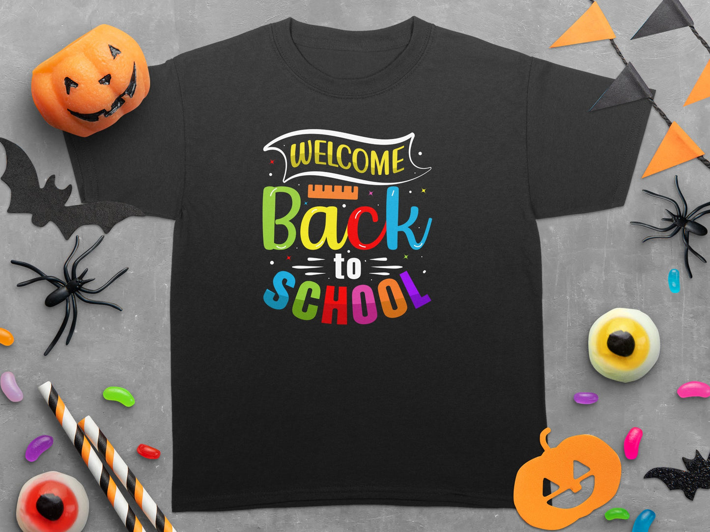 Black t-shirt with "Welcome Back to School" text and Halloween decorations.