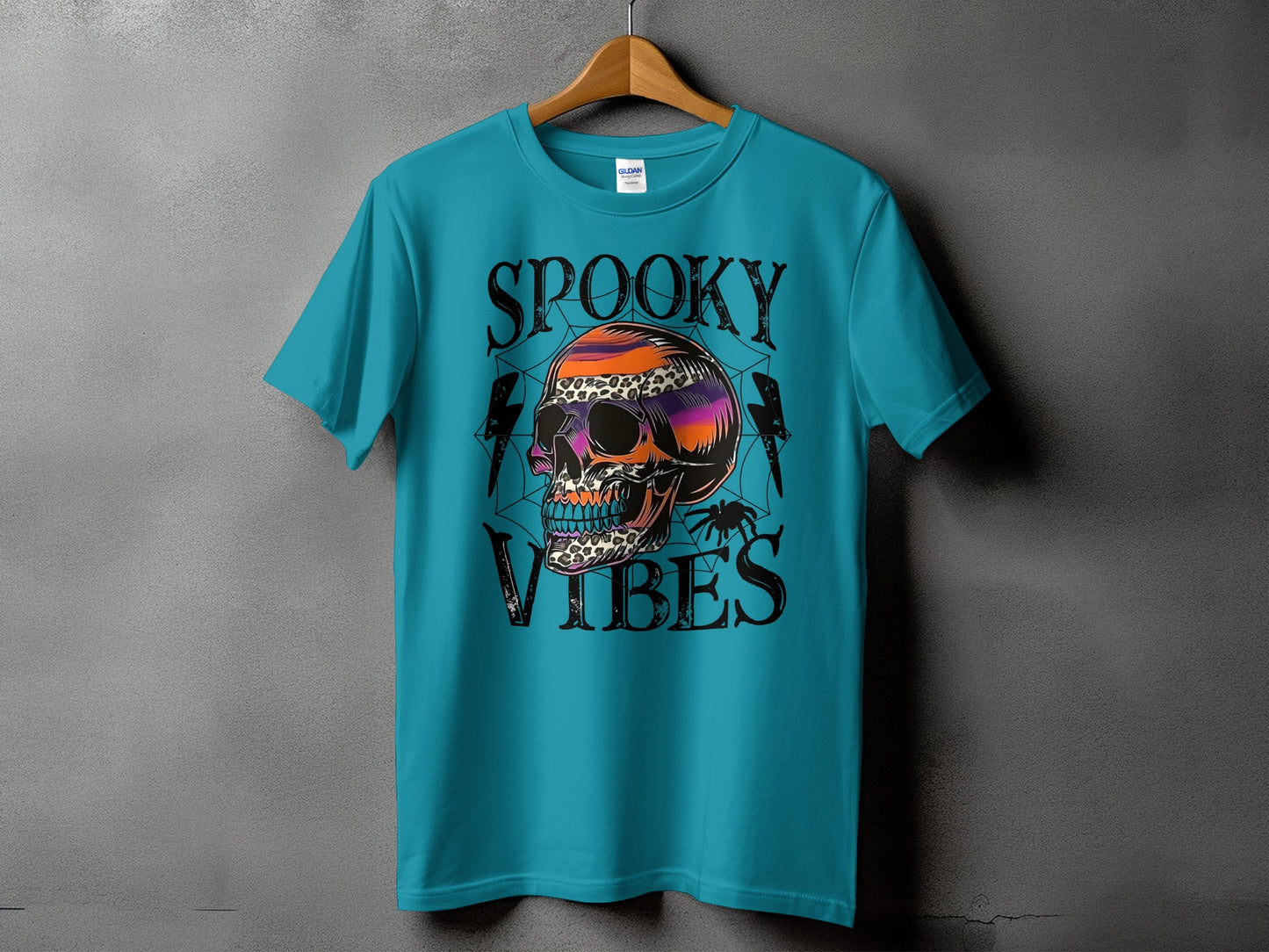 Teal t-shirt with "SPOOKY VIBES" text and colorful skull graphic.
