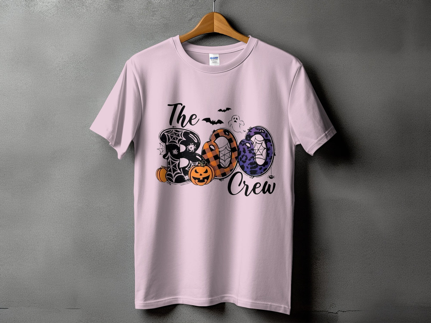 Light pink t-shirt with "The Boo Crew" Halloween graphic featuring pumpkins and bats.