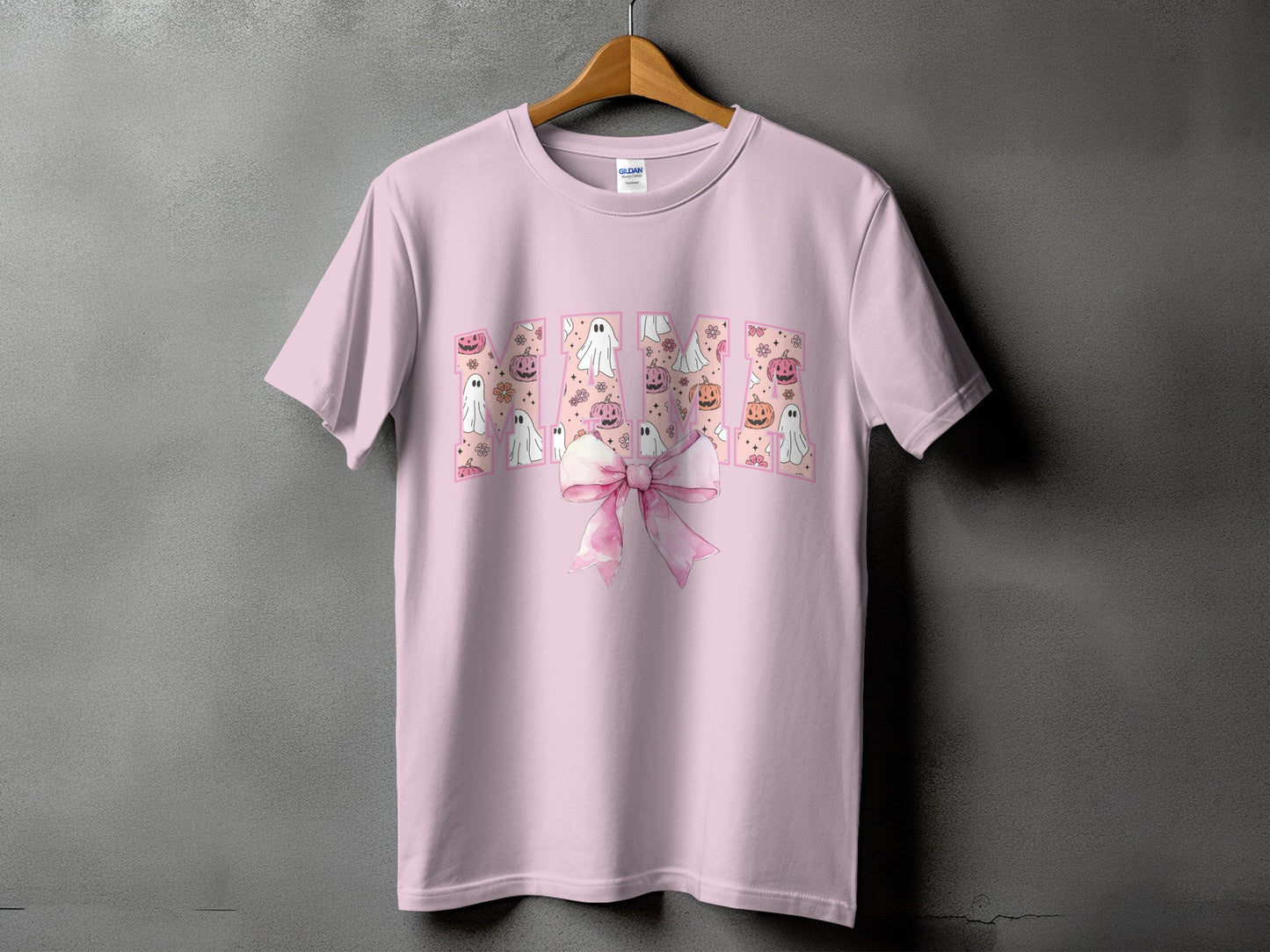 Pink t-shirt with "Mama" text filled with Halloween ghosts and pumpkins.