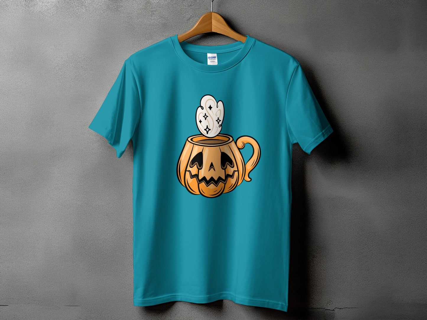 Teal t-shirt with a cartoon jack-o'-lantern mug graphic on the front.