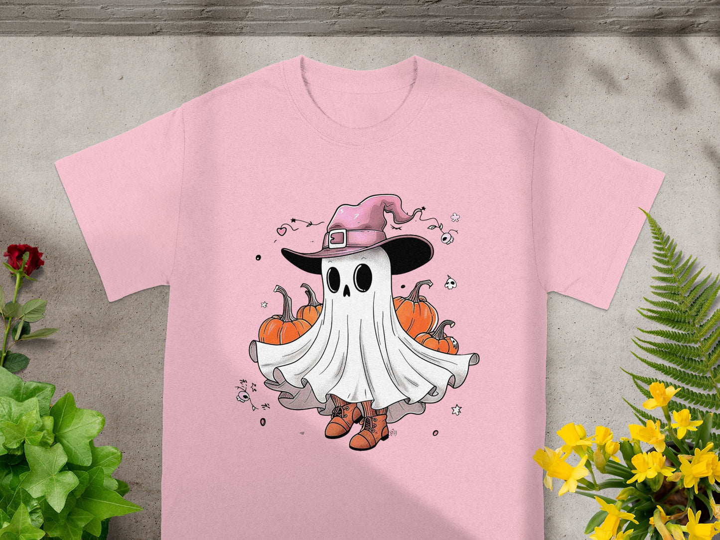Pink t-shirt with cartoon ghost wearing witch hat and holding pumpkins.