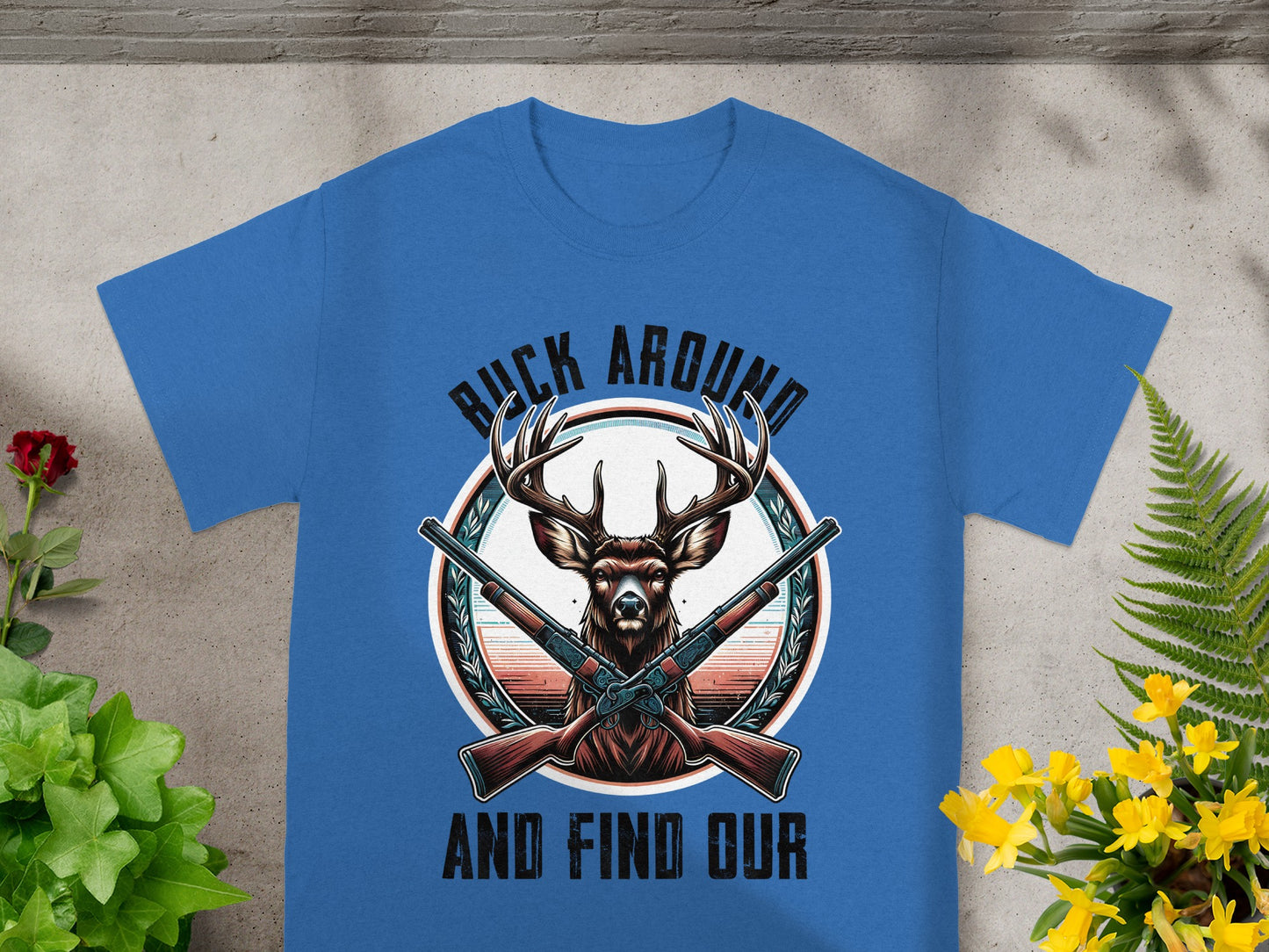 T-shirt with deer, guns, and text "Buck Around and Find Our".
