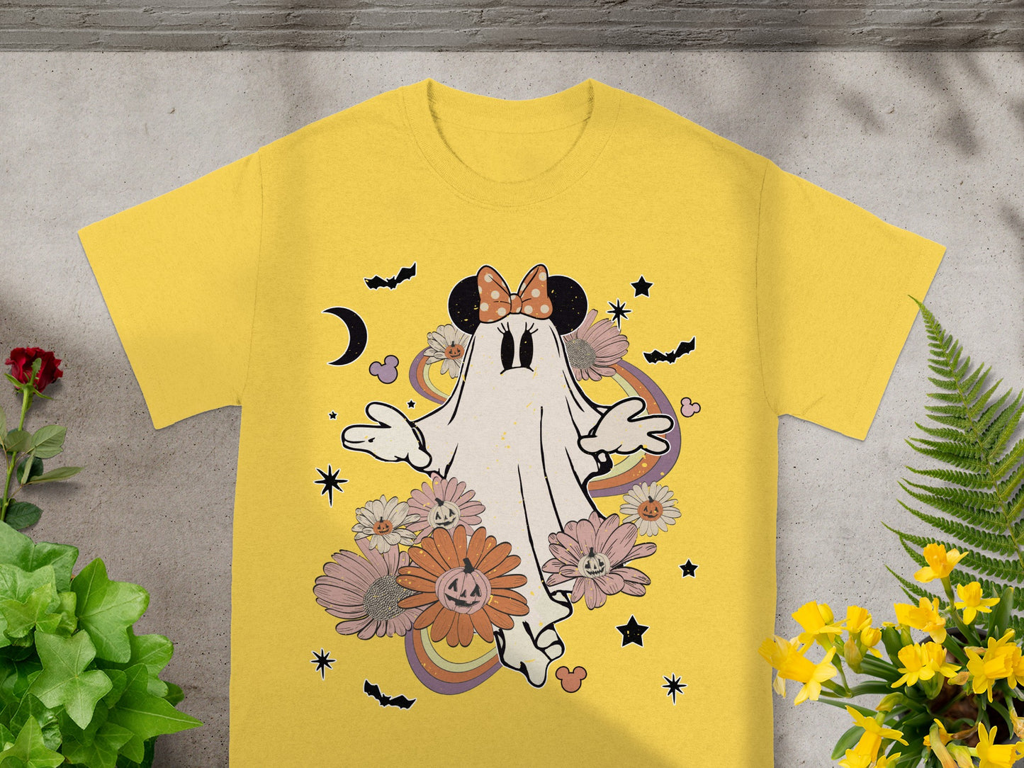 Yellow t-shirt with a ghost wearing Minnie Mouse ears and Halloween-themed flowers.