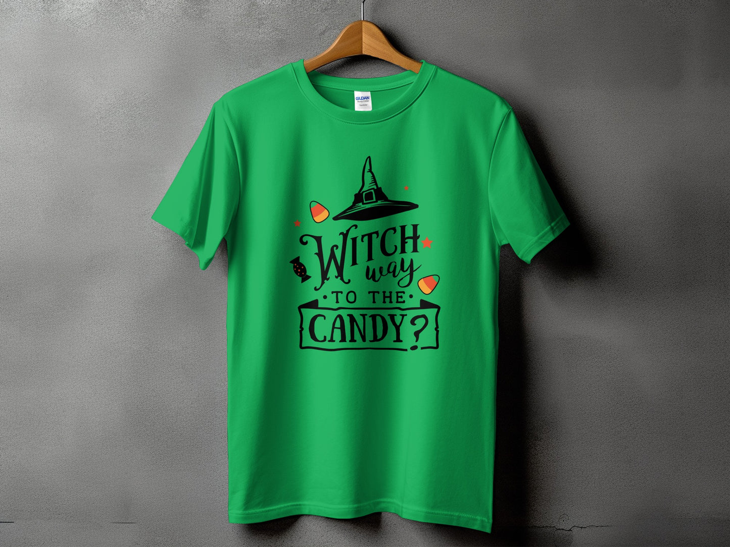 Green t-shirt with black text and graphics saying "Witch way to the candy?".