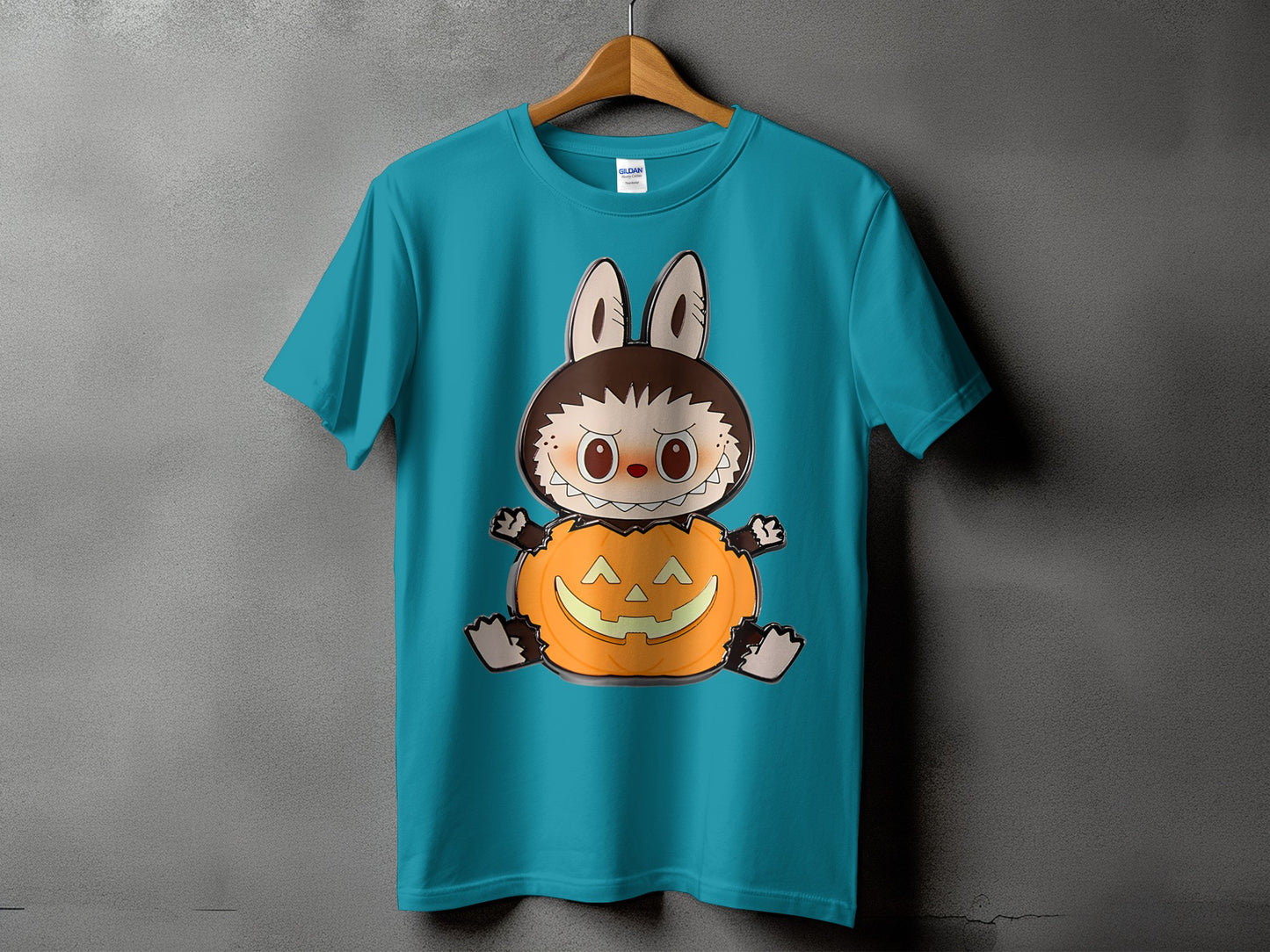 Teal t-shirt with a cartoon character sitting in a jack-o-lantern.