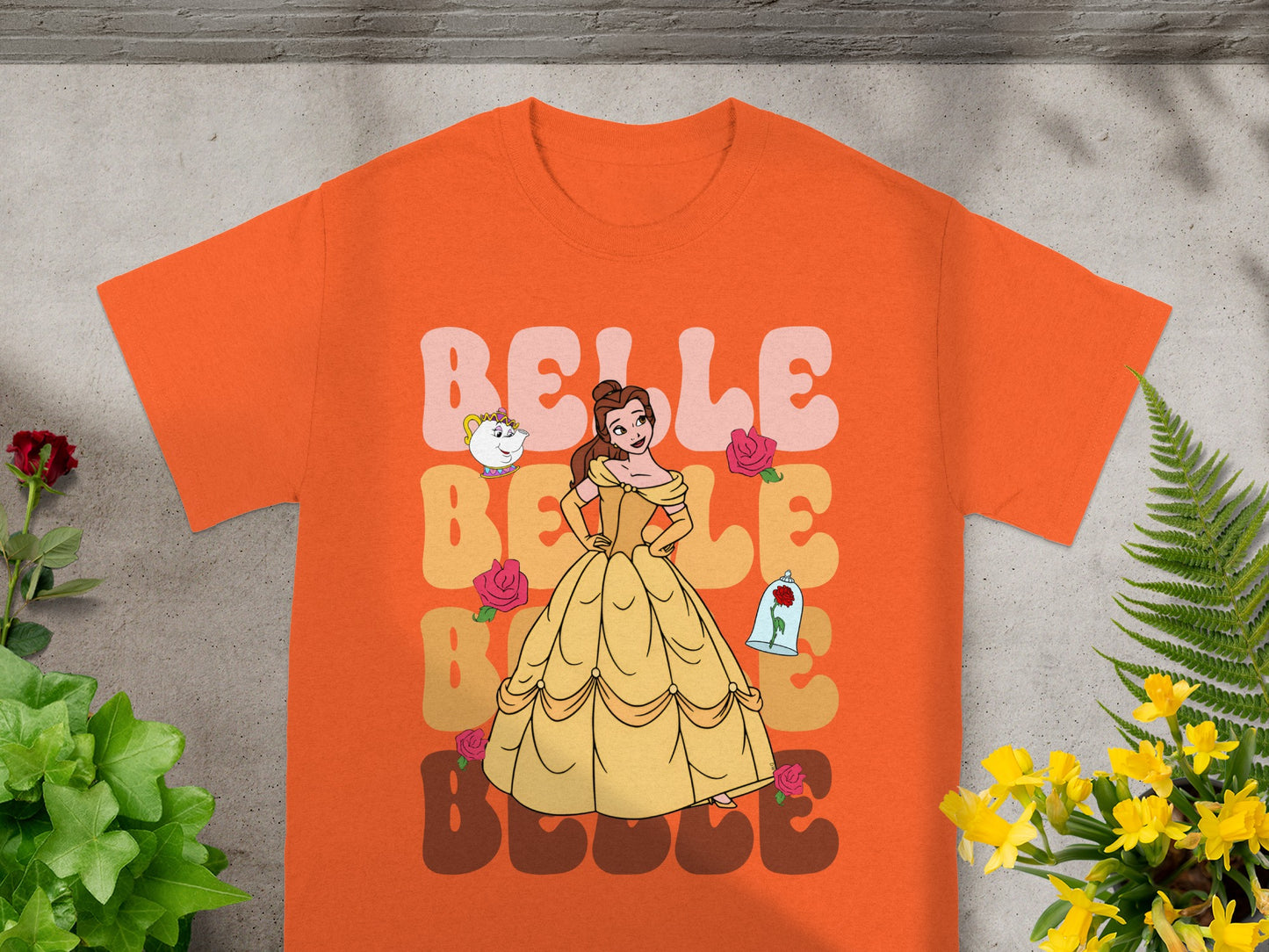 Orange t-shirt with Belle from Beauty and the Beast and roses graphic.