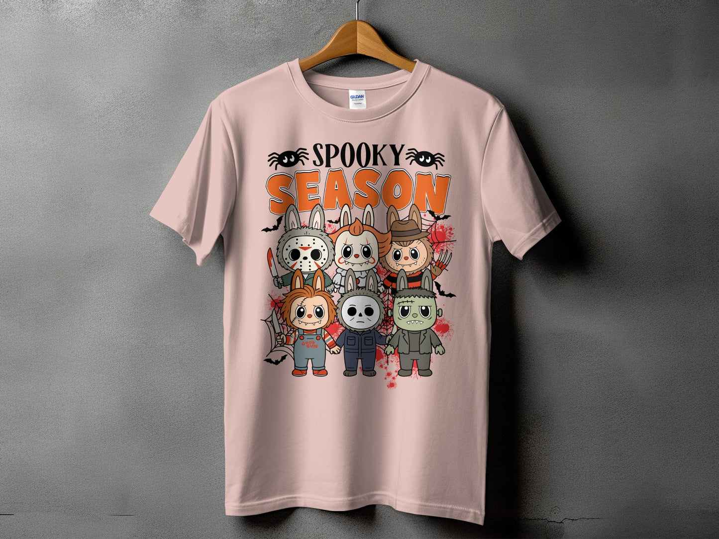 Pink t-shirt with "Spooky Season" text and horror movie characters dressed as bunnies.