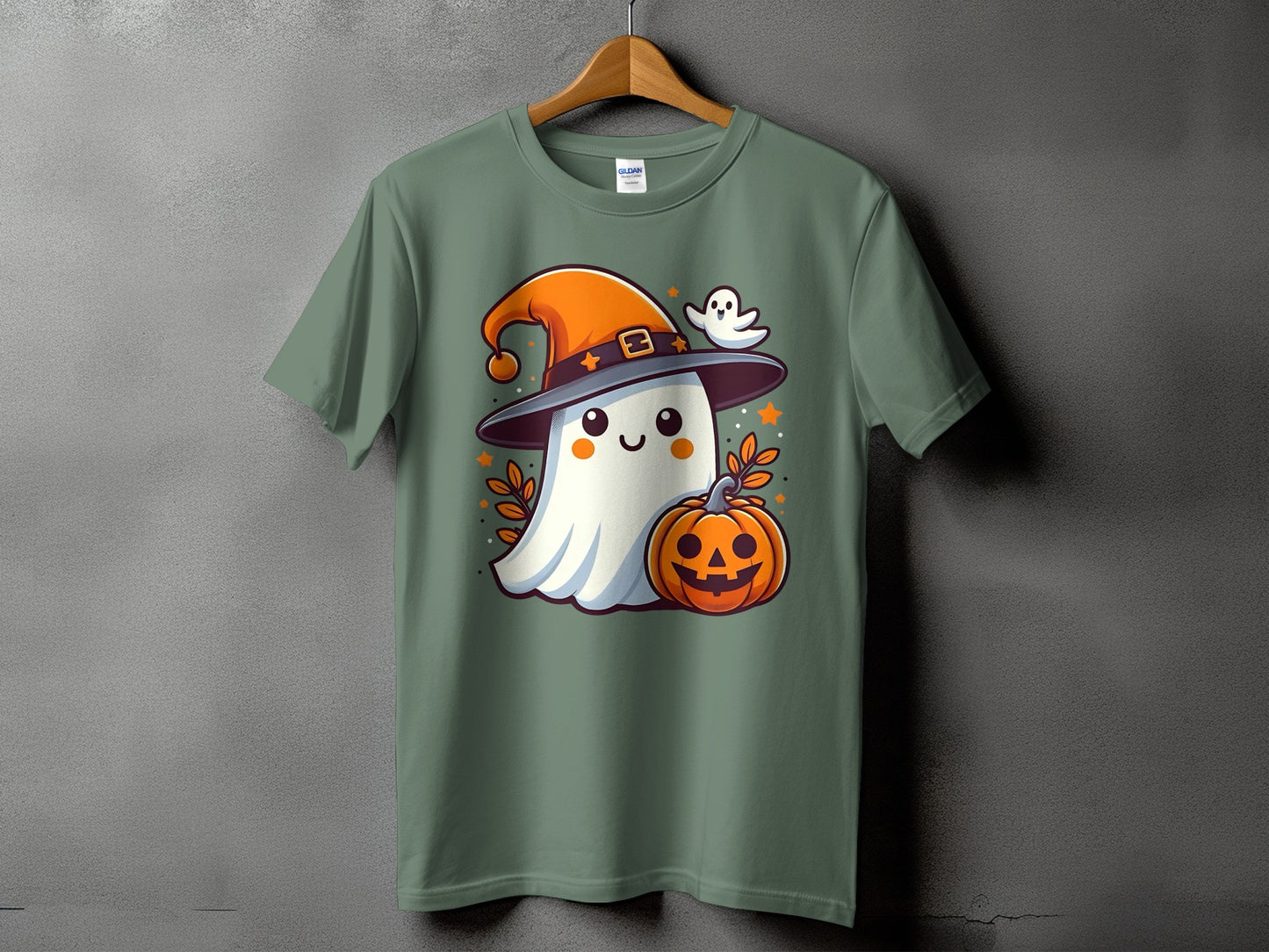Green t-shirt with a cartoon ghost wearing a witch hat holding a pumpkin.