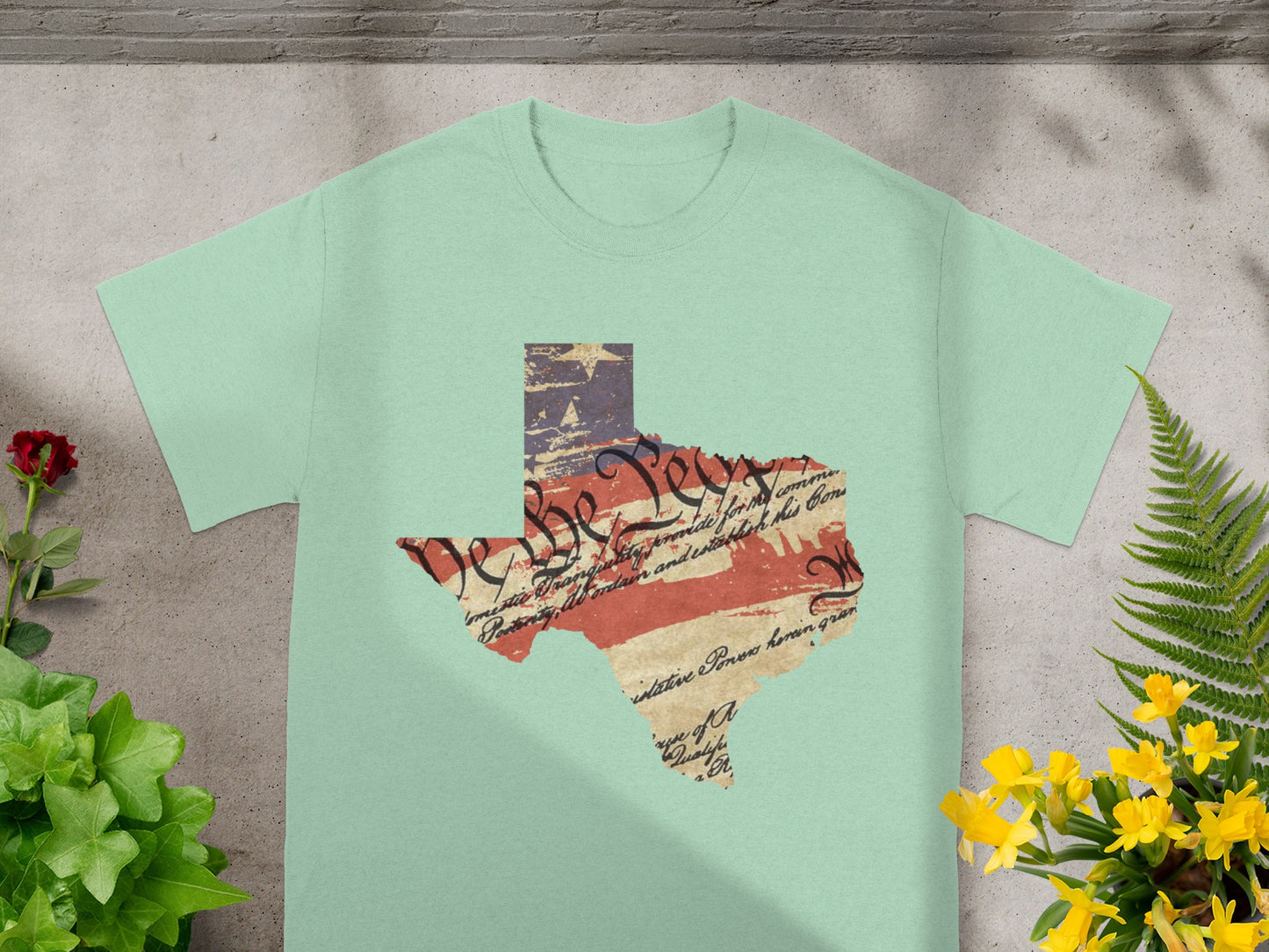 Texas state outline on pale green shirt with distressed US flag and Constitution text.