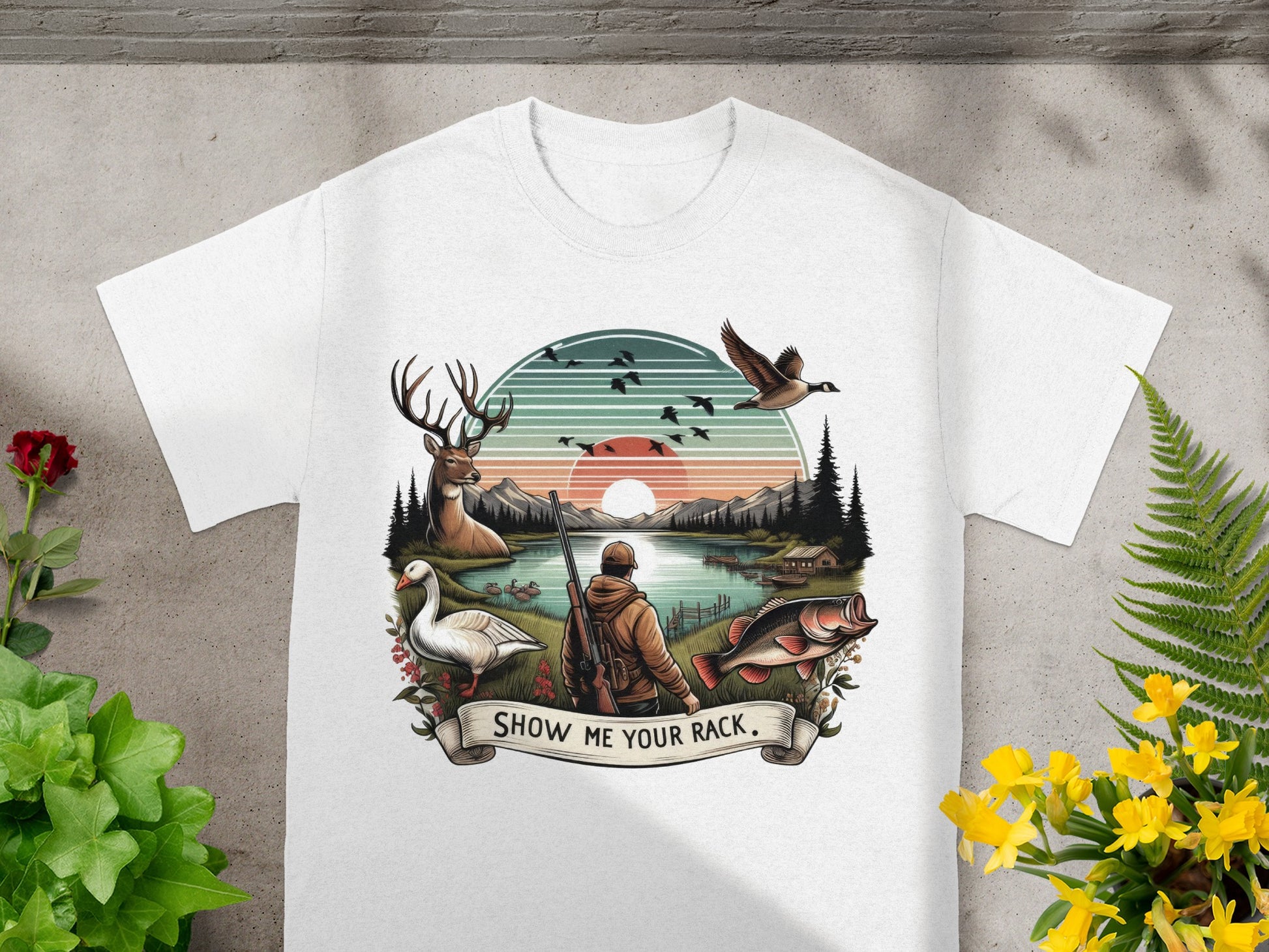 White t-shirt graphic with hunting and fishing scene, "SHOW ME YOUR RACK" text.