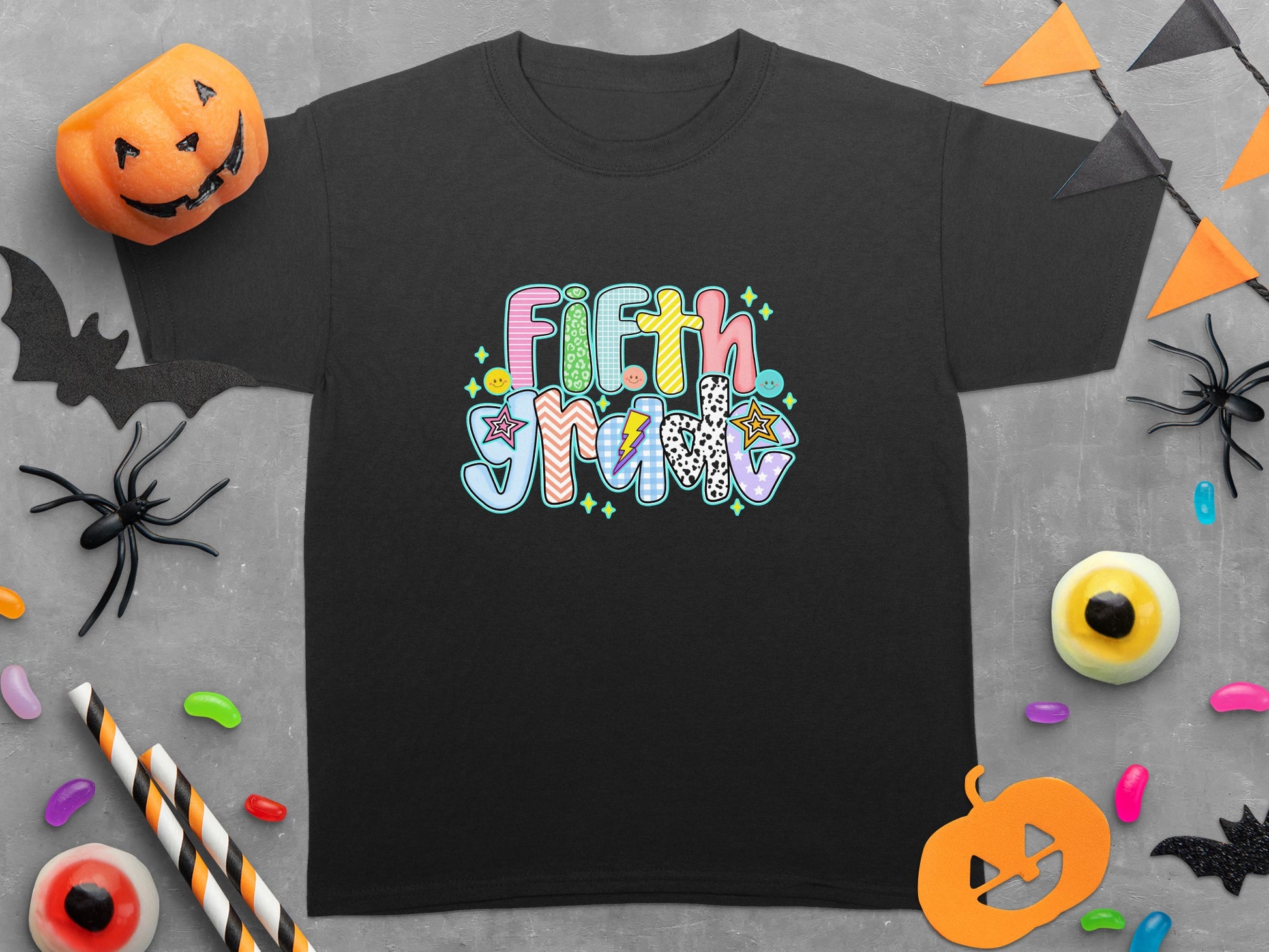 Black t-shirt with "Fifth Grade" text in colorful, patterned lettering.
