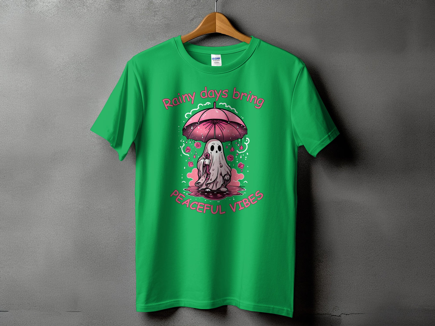 Green t-shirt with a ghost holding an umbrella, surrounded by roses and text.