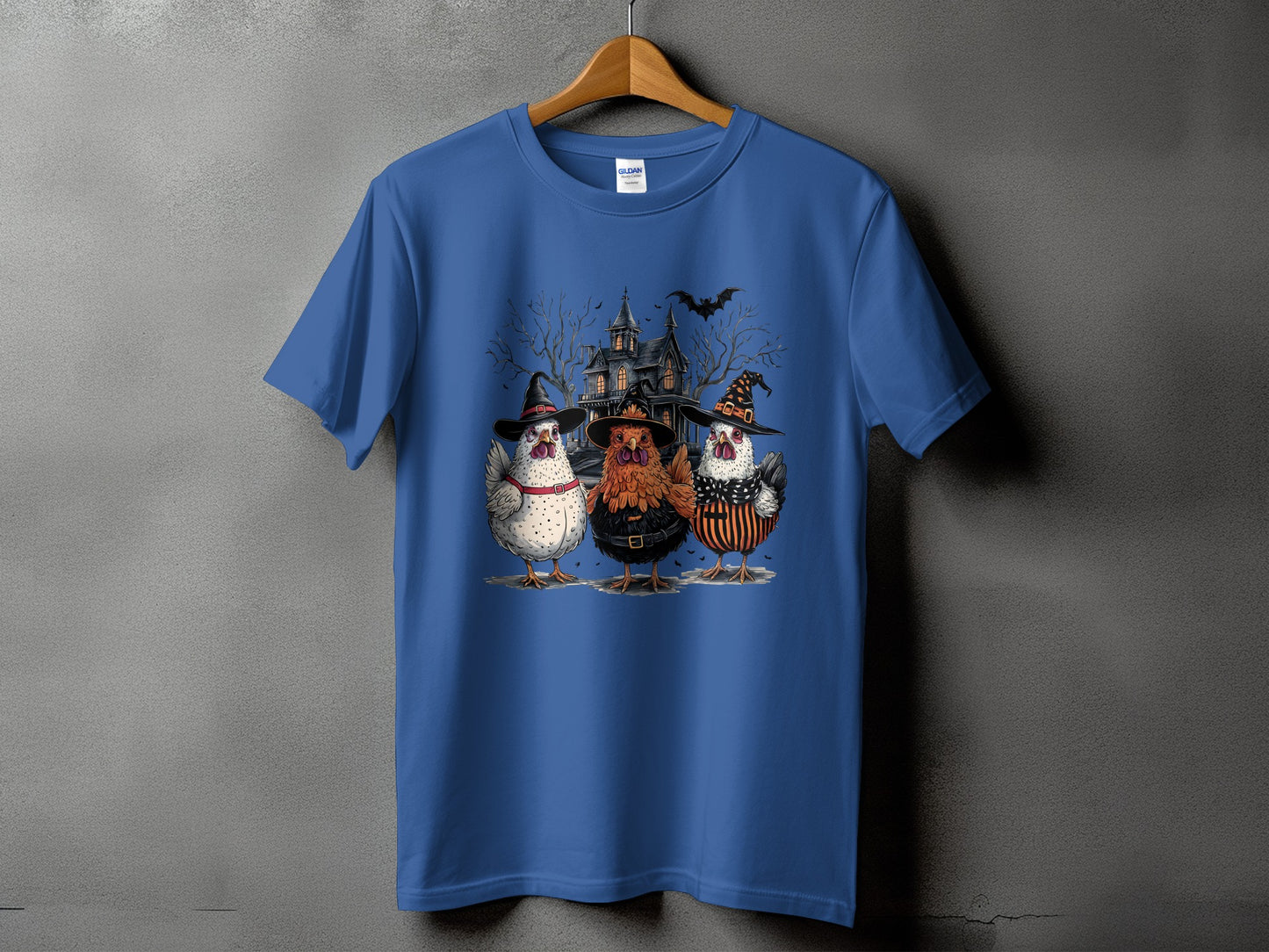 Three chickens in witch hats stand before a spooky haunted house.