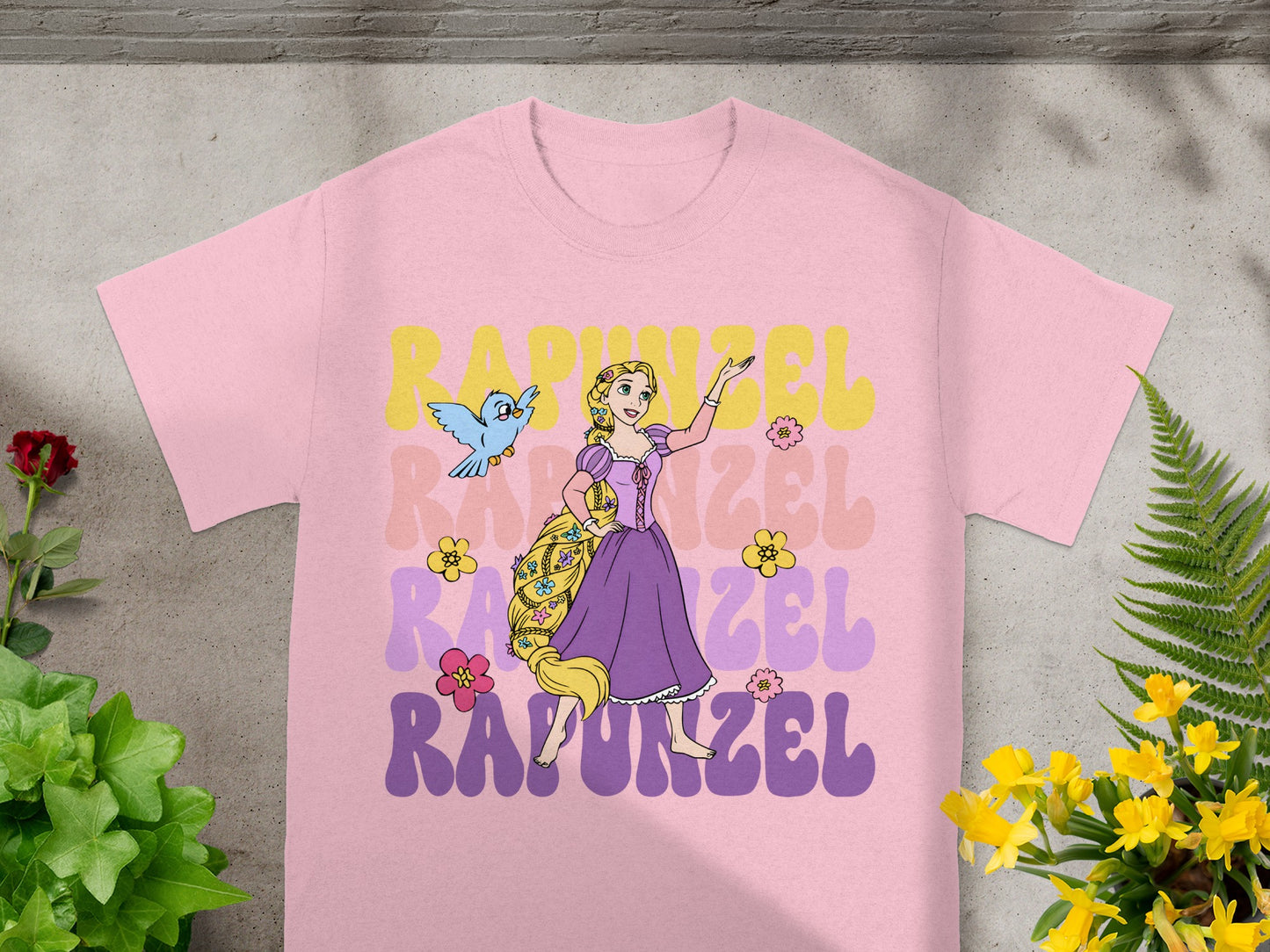Pink t-shirt with Rapunzel and Pascal graphic and text.