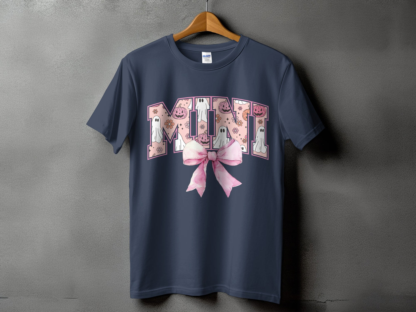 Navy t-shirt with "MIMI" text featuring ghosts, pumpkins, and flowers, with a pink bow.