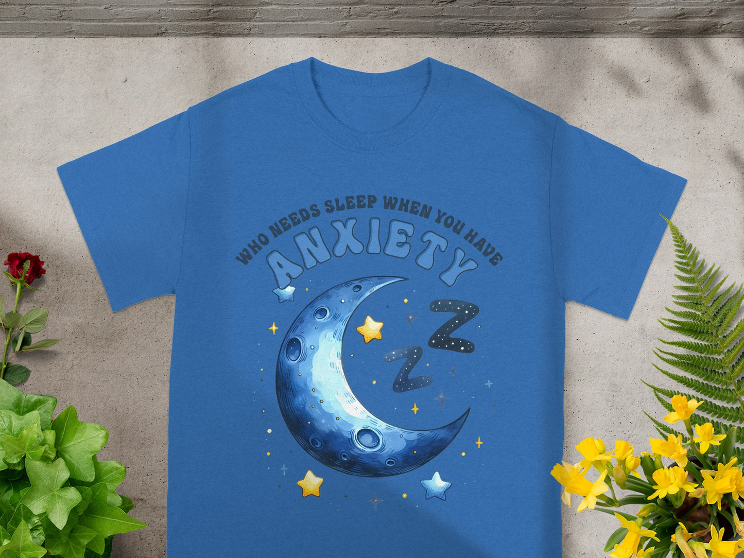 Blue t-shirt with a crescent moon, stars, and the text "Who needs sleep when you have anxiety".
