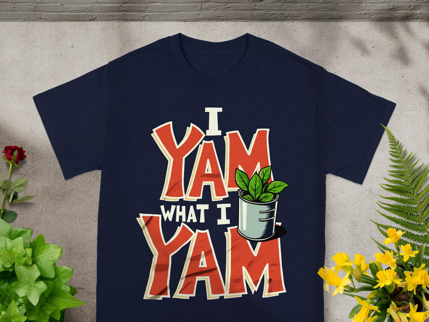 Navy t-shirt with "I YAM WHAT I YAM" text and plant in a pot.