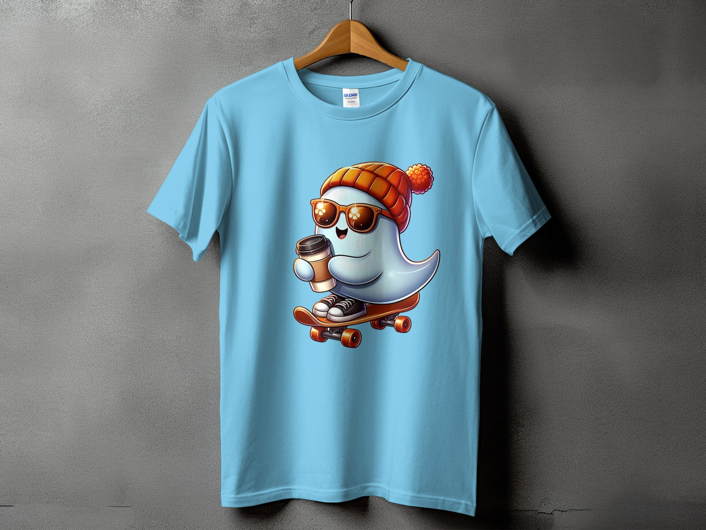 Light blue t-shirt with a cartoon ghost wearing a beanie and sunglasses, riding a skateboard with a coffee cup.