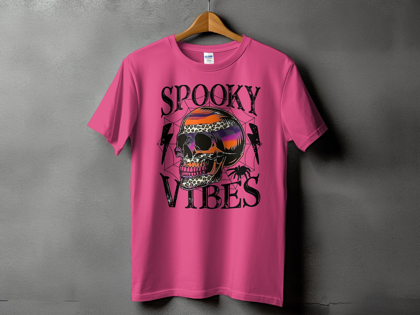 Pink t-shirt with "Spooky Vibes" text and a skull graphic featuring leopard print.