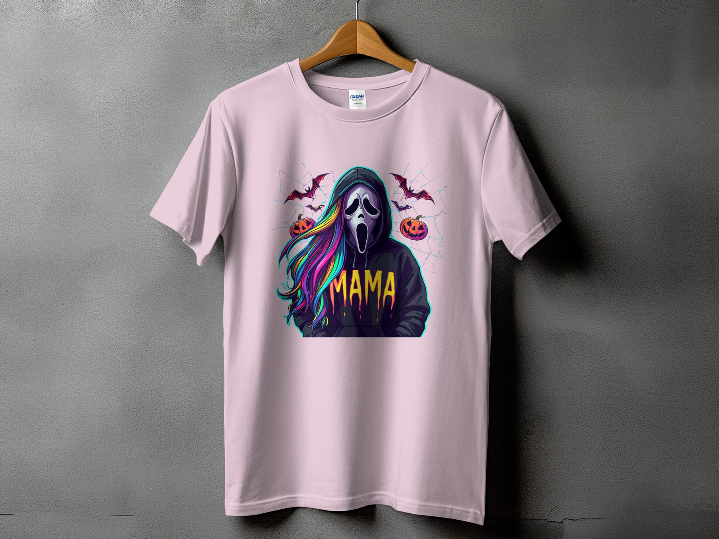 Pink t-shirt with a graphic of a ghost face, pumpkins, bats, and the word "MAMA".