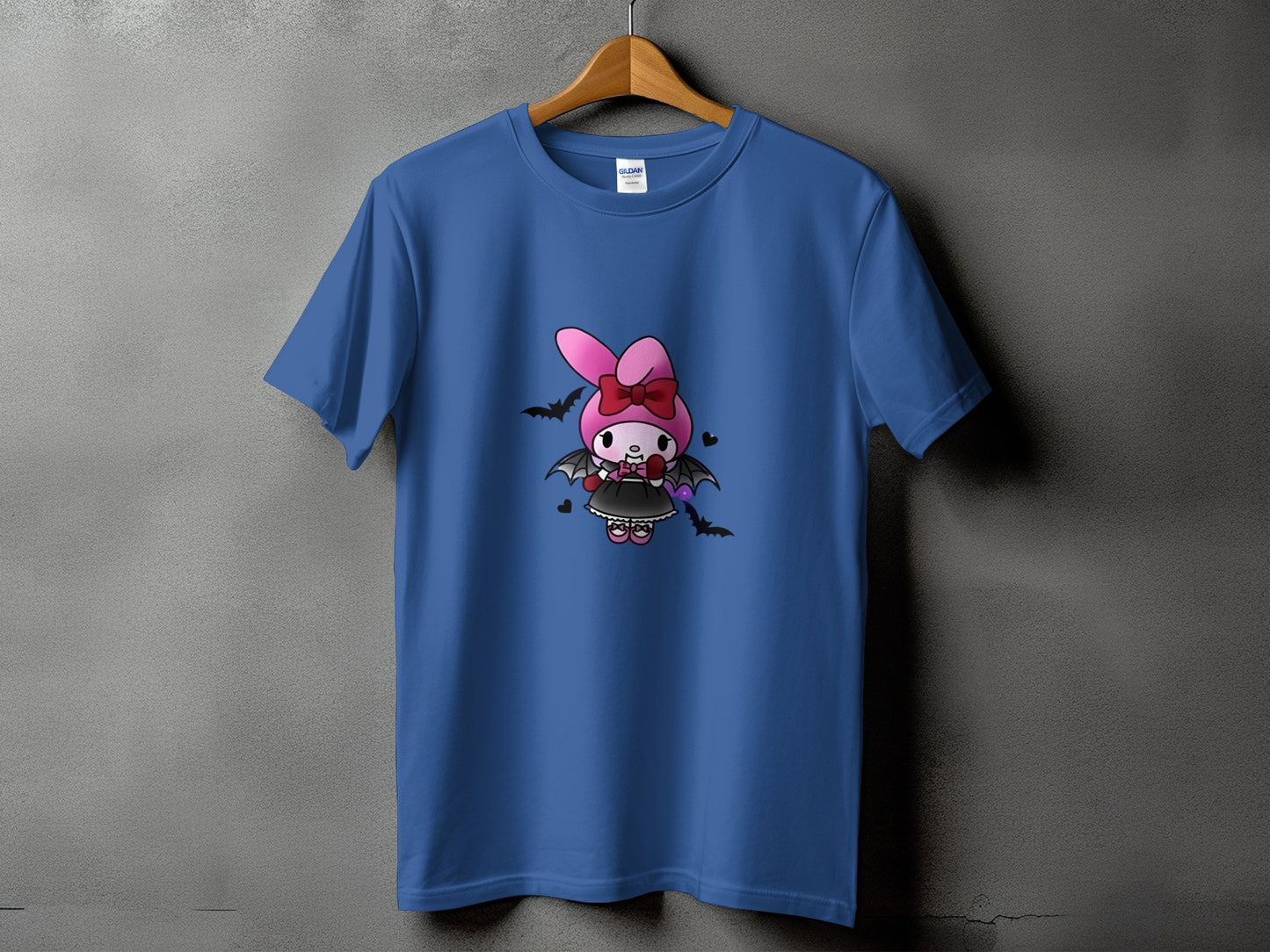 Blue t-shirt with a cartoon bat-winged bunny character wearing a bow and dress.