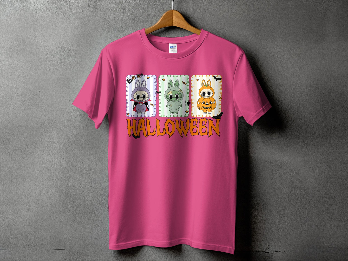 Pink t-shirt with three cartoon Halloween characters and the word Halloween.