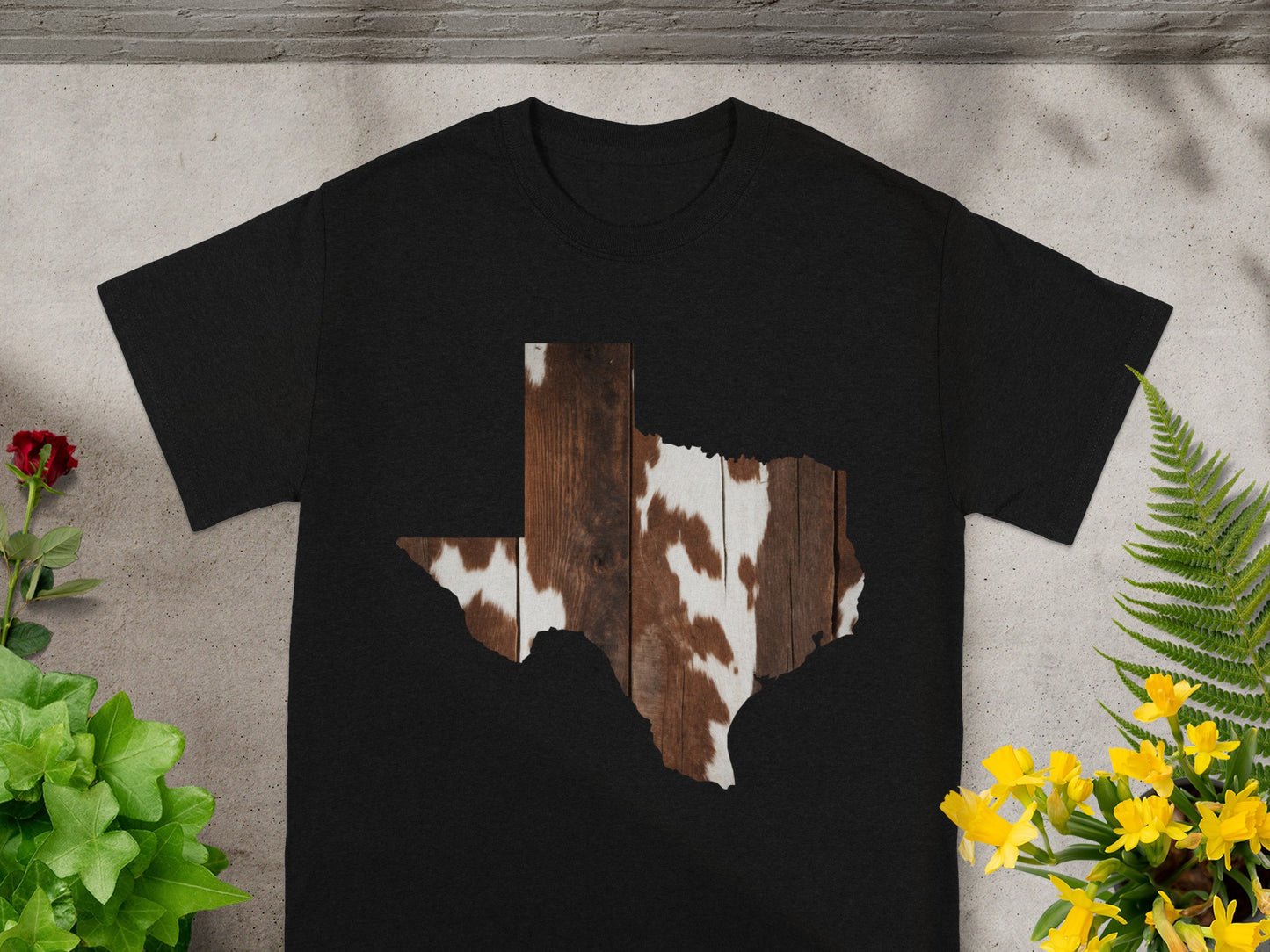 Black t-shirt with Texas shape filled with wood and cowhide pattern.