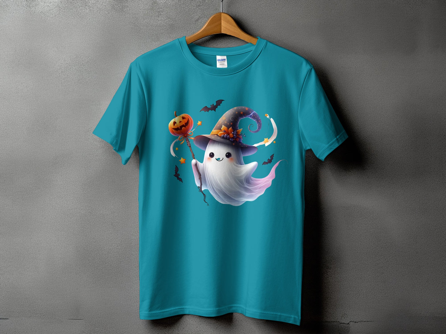 Teal t-shirt with a cute ghost wearing a witch hat holding a pumpkin on a stick.